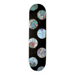 Colorful blue green red circles on black skateboard deck