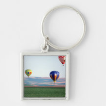 Colorful hot air balloons float over wheat key chains
