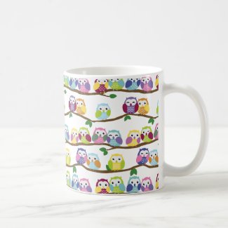 Colorful owls on a branch coffee mug