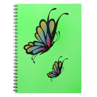Colorful Rainbow Butterflies on Green Notebook