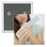 Contraceptive pills in a woman's hand. pins