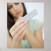 Contraceptive pills in a woman's hand. print