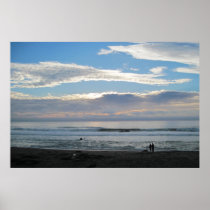 Couple on Beach Gazing into Sunset and Ocean Poster