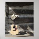 Cowboy hat on guitar leaning on log cabin print