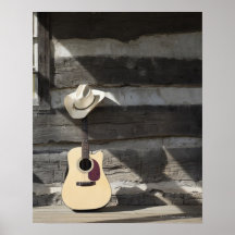 Cowboy hat on guitar leaning on log cabin print