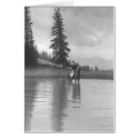 Cowboy on a horse standing in a pond drinking from cards