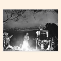 Cowboys playing and singing around a campfire postcards