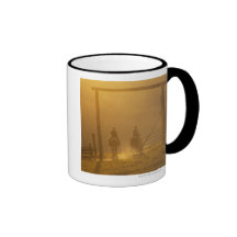 Cowboys riding through gate at dusk coffee mug