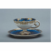 Cup and saucer with colorful designs cut out