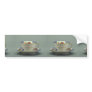 Cup and saucer with colorful flower designs on it. bumper sticker