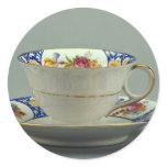 Cup and saucer with colorful flower designs on it. stickers