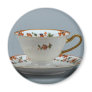 Cup and saucer with colorful flowers on it. fridge magnet