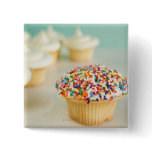 Cupcakes, focus on one in front with pinback button