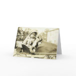 Cute girl in a peddle car greeting card