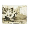 Cute girl in a peddle car postcard