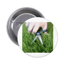 Cutting the grass with a pair of scissors pinback buttons