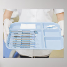 Dental hygienist  holding tray of dental posters
