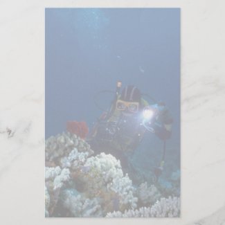 Diver shooting video on coral bed stationery paper