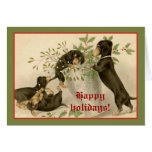 Dogs playing with Christmas mistletoe & holy berry Greeting Cards