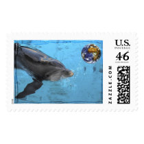 Dolphin playing with Earth postage