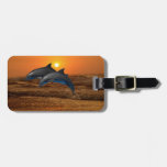 Dolphins at sunset luggage tag