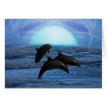 Dolphins playing at moonlight greeting card