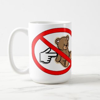 A white mug,There is a red circle with a red bar across the image of a toy bear as a gloved hand with a pointing finger comes in from the left to poke the bear. Don't Poke the Bear Mug
