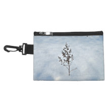 Dry branches tree sticking out of the snow accessory bags