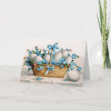 Easter Basket Card - A beautiful wicker basket filled with white eggs and surrounded by the brightest blue little flowers with a few pink ones here and there. The blue ribbon matches the flowers perfectly. This type of Victorian print was popular in the early 1900's.
