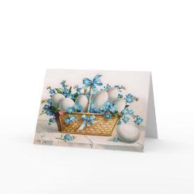 Easter Basket Card - A beautiful wicker basket filled with white eggs and surrounded by the brightest blue little flowers with a few pink ones here and there. The blue ribbon matches the flowers perfectly. This type of Victorian print was popular in the early 1900's.