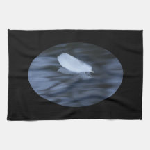 feather floating on blue water towel