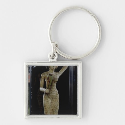 Female bearer of offerings carrying a water key chain