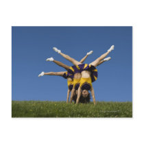 Female cheerleaders doing handstands postcards