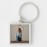 Female gymnast (12-13) performing splits keychain