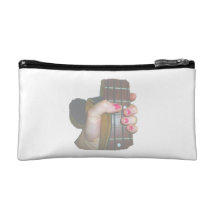 female hand holding four string bass neck faded makeup bag