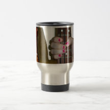 female hand holding four string bass neck coffee mugs