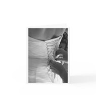 Female hand lacing up wedding dress back card