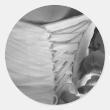 Female hand lacing up wedding dress back round sticker