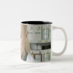 Female pharmacist looking at medicine in mugs