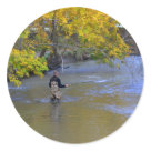 round_sticker - Man fly fishing in the creek.