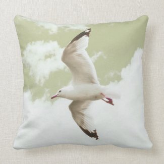 Flying seagull by the sea throw pillow