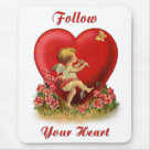 standard_mousepad - Cute dancing cherub is playing a flute. This musical angel has his eye on a butterfly. Flowers bloom at his feet. Big red heart in background. Text says Follow Your Heart. An adorable vintage design offered on gift items and clothing.: Sizes 