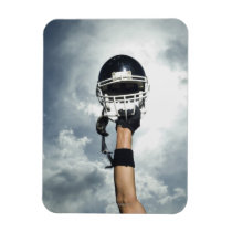 Football player holding helmet in air magnets