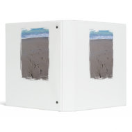 Footprints in beach sand blue ocean in back binder