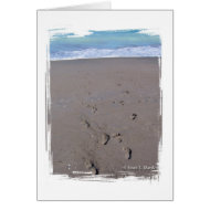 Footprints in beach sand blue ocean in back card