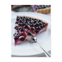 Fork slicing blueberry pie on plate postcards