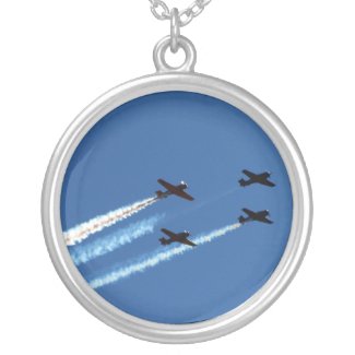 four flying planes with trails blue sky necklace