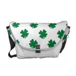 Four leaf clovers in green courier bag