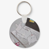 Frenchy resting on laptop keychains