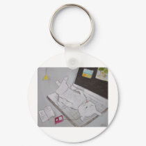 Frenchy resting on laptop keychains